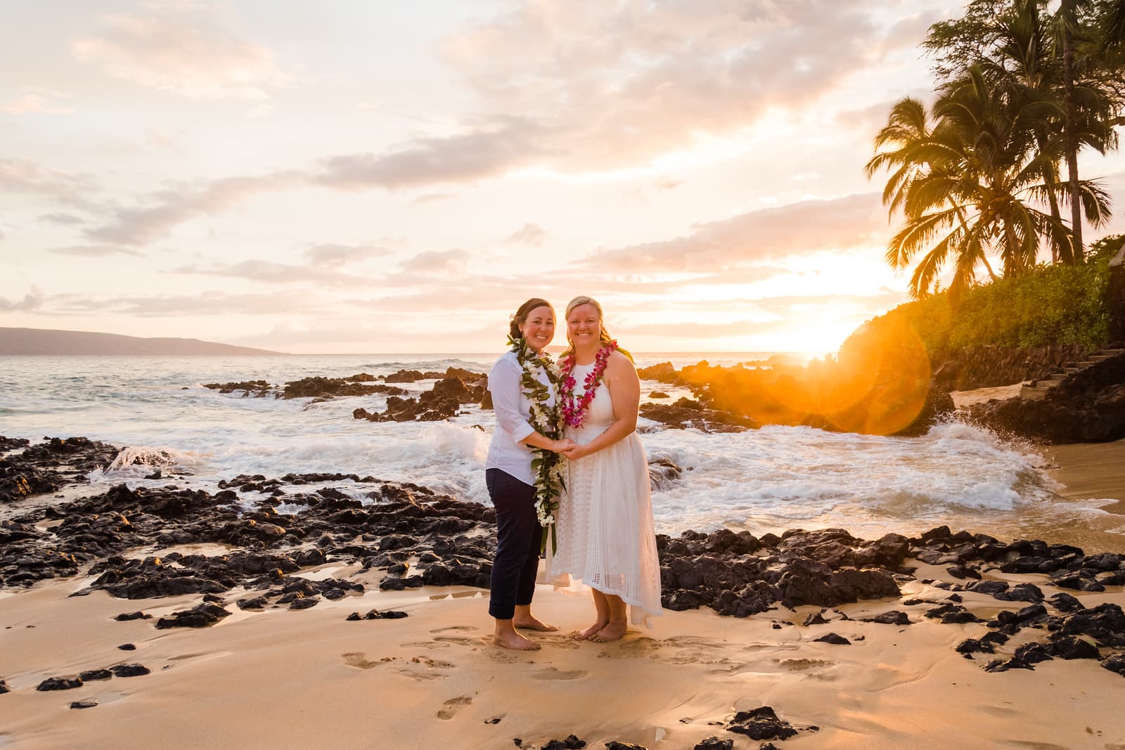 Two brides at their sunset beach ceremony at Makena Cove in Maui, Hawaii.