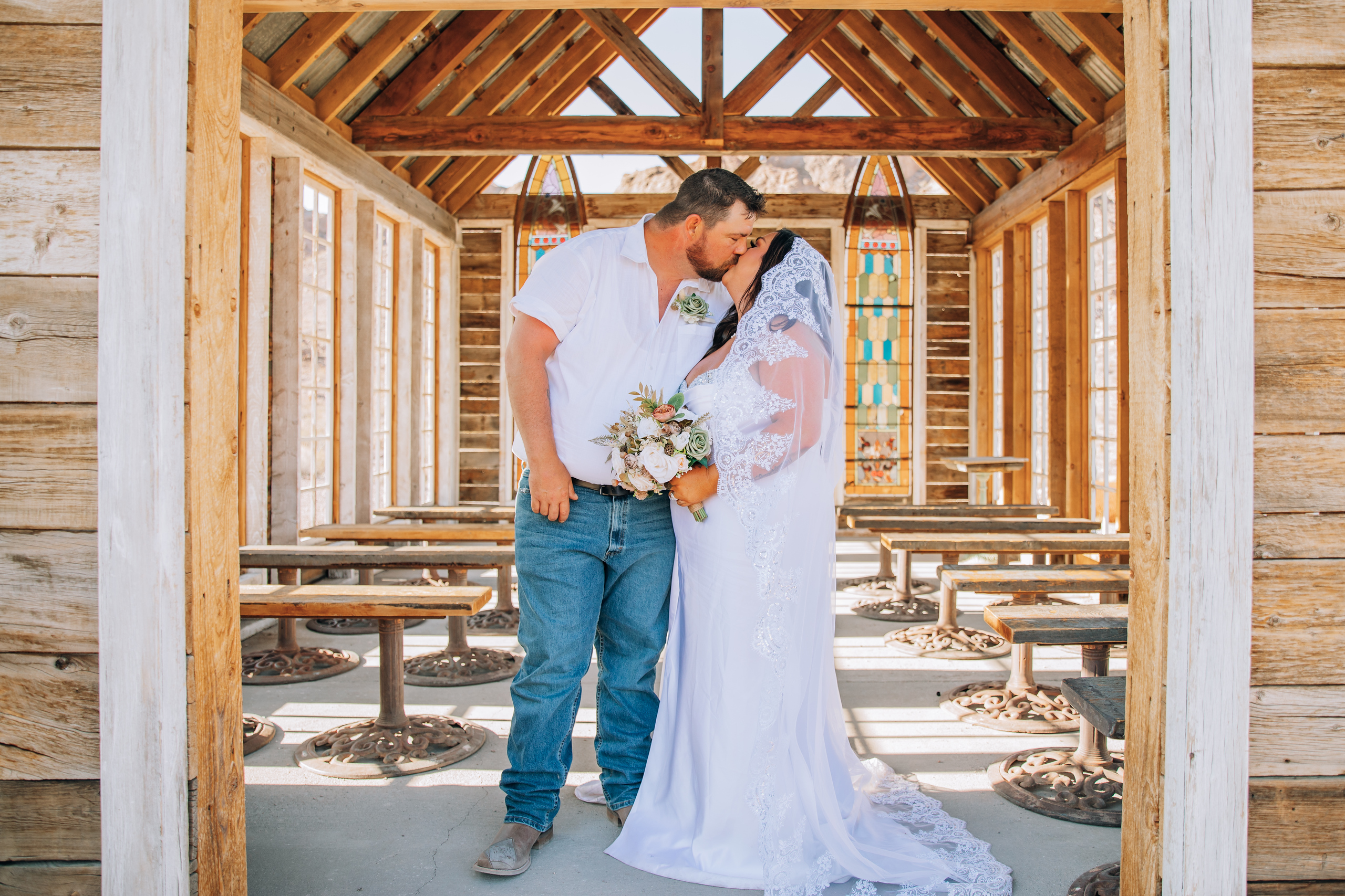 A bride and a groom exchange a kiss after their elopement in Nelson Ghost Town's cathedral in Las Vegas.